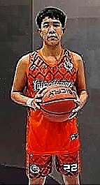 Standing in red uniform #22 is basketball player James Ramirez, San Isidro Labvrador team in the Junior Division of the Inter Purok Basketball TYournament.
